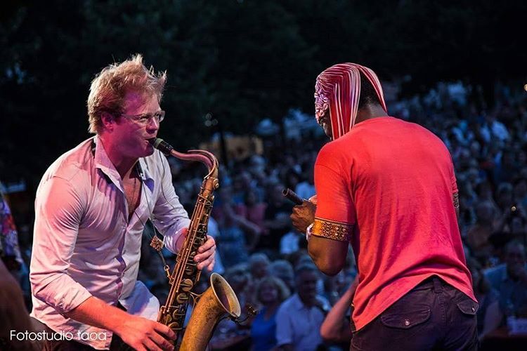 Viktor Wolf playing tenor saxophone live on stage